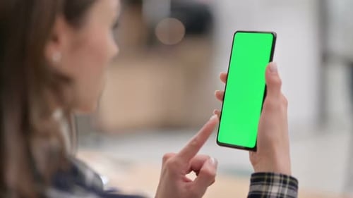Female Watching Smartphone with Green Chroma Key Screen
