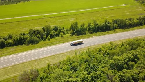 Truck Travels Along a Highway in Rural Landscape