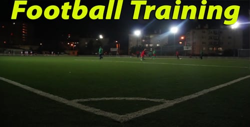 Soccer Players on a Field at Night