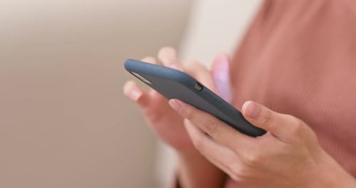 Hands Using Mobile Phone with Blue Case