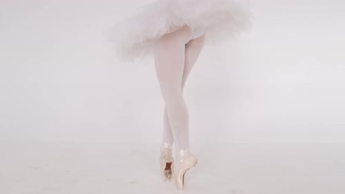 Woman Dancing Gracefully in Ballet Studio