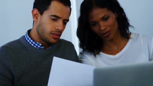 Man and Woman Working Together on Documents