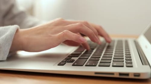 Woman Using on Notebook Computer at Home