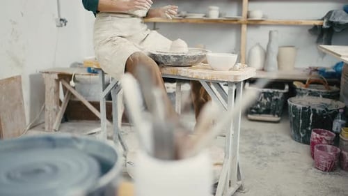 Tracking Shot of Unrecognizable Potter Working with Pottery Wheel at Workroom Close Up Slow Motion