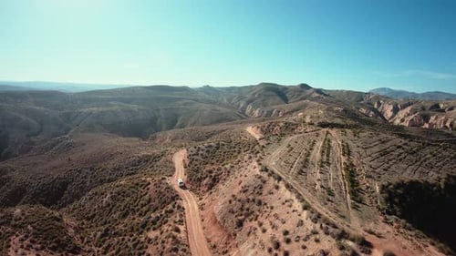 Aerial Shot of Camping Van on Gravel Mountain Road