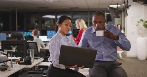 Professional businesswoman and businessman working together in modern office in slow motion