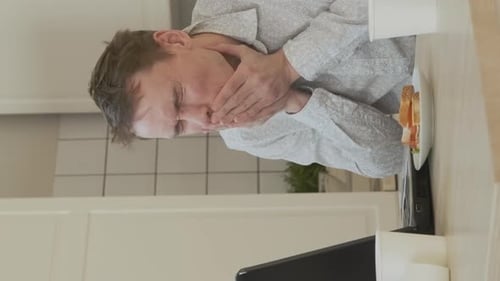 Young Adult Working on Laptop at Table