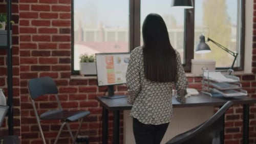 Woman Working at Computer in Modern Office