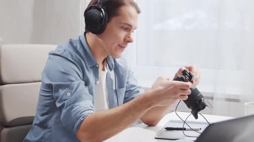 Workplace of freelance worker at home office. Young man works using computer.