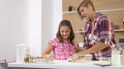 Mother and Daughter Baking Together in Kitchen