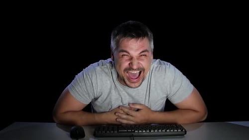 Man at Keyboard Laughing Hysterically