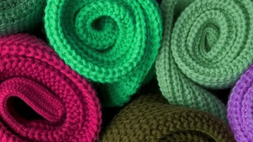 Close Up of Knitted and Rolled Colorful Fabric