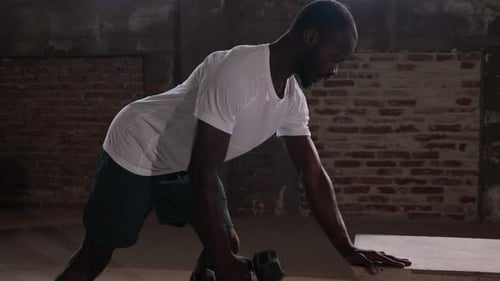 Sport man doing back exercise workout with weight at gym