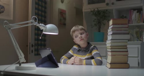 Preschool Child Choosing Paper Books or Tablet Computer with Eyes