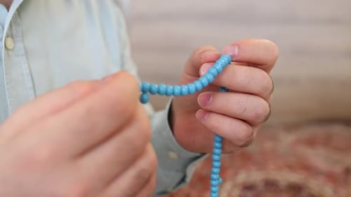 Muslim betet mit Rosenkranz in der Moschee