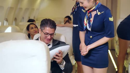 Flight Attendant Helping a Passenger on an Airplane