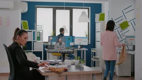 Coworkers Taking a Pizza Break During Online Meeting
