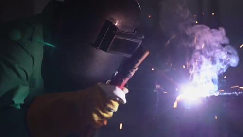 Welder Sparks Metal in the Darkness