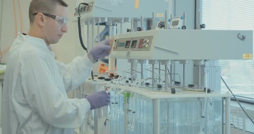 Scientist Working with Laboratory Equipment and Test Tubes