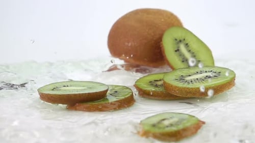 Kiwi Fruit Slices Falling Into Water