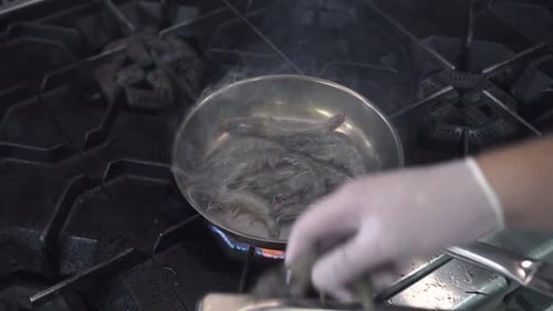 Man Puts Royal Shrimps Into Frying Pan in Seafood Restaurant