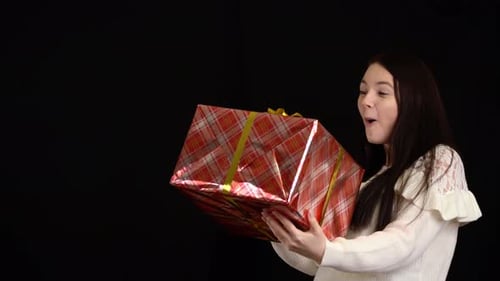 Woman Receives a Birthday Present with Excitement