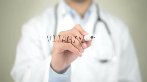 Doctor Writing Vitamin C with a Marker