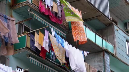 Clothes Hanging and Drying on a Rope on a Multi-story Building in a Poor District of the City