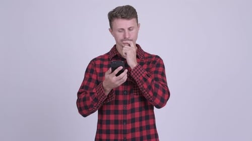 Man Typing and Thinking While Using Phone