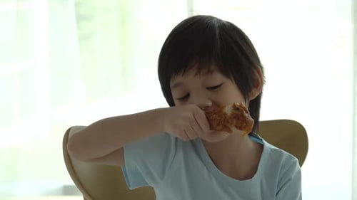 Enthusiastic Boy Eating Crispy Fried Chicken