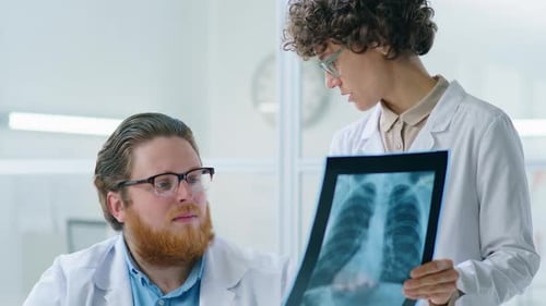 Doctors Analyzing X-Ray in Bright Office Setting