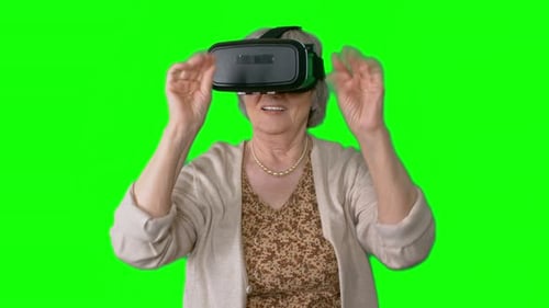 Senior Woman Using Virtual Reality Headset on Green Screen