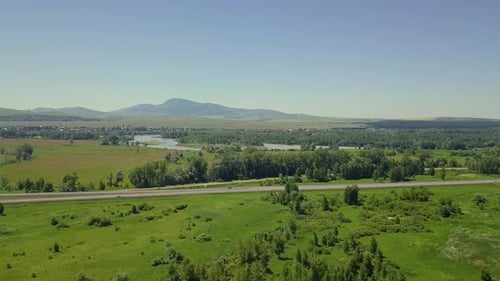 Aerial: Flying Over the Highway, Forest and Field. View of the Tourist City, Mountain River