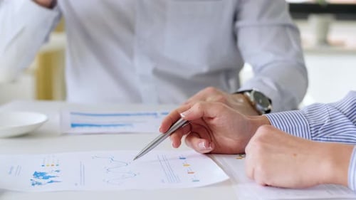 Business Team with Charts at Office Meeting