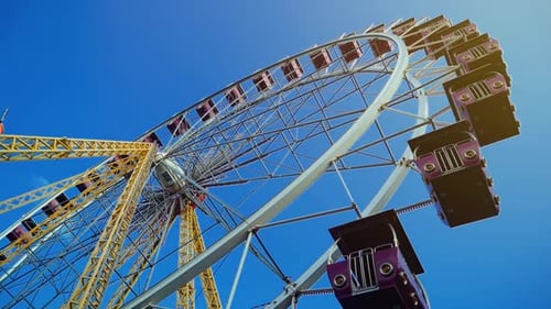 Bright Ferris Wheel Against Clear Blue Sky