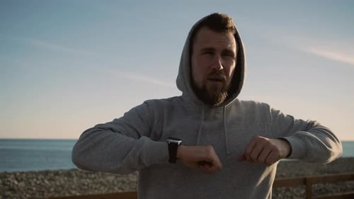 Man Stretching on Beach Before Exercise