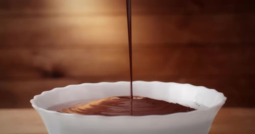 Dark Chocolate Pouring Into a Bowl, Close-up