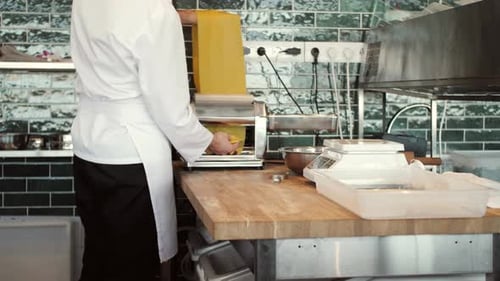 Chef Making Fresh Pasta at Restaurant Counter