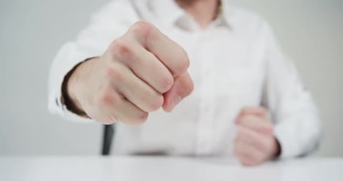 Adult clenching fists in conflict or anger