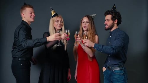 Friends Toasting with Champagne Wearing Party Hats