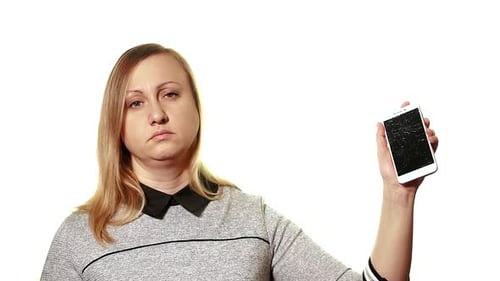 Woman Holds Broken Smartphone with Shattered Screen