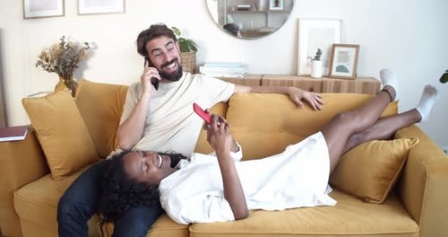 Couple Relaxing on Couch with Cell Phones