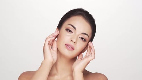 Studio portrait of young and beautiful brunette woman over