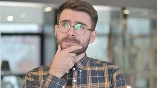 Man With Glasses Thinking Deeply Close Up
