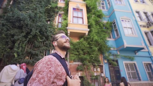 Man Walking on Street in Colorful City