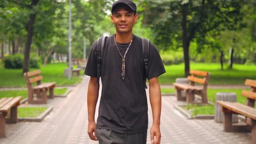 The Guy Walks in the Park, Smiling.