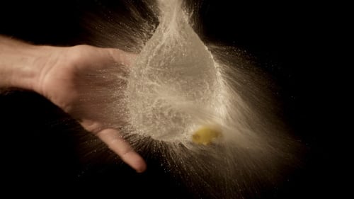 Yellow Balloon Filled with Water Pops in Slow Motion