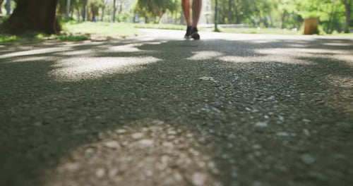 Low section of senior man running in the park