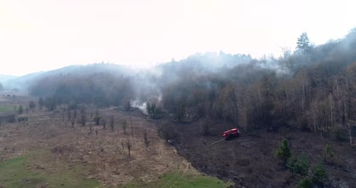 Fire Truck Fighting Brush Fire on Hillside
