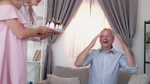 Man Surprised with Birthday Cake by Family